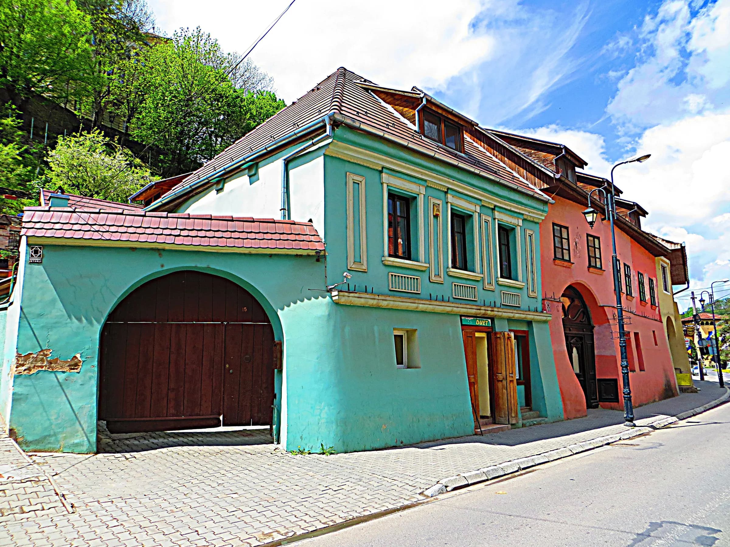 Turquoise and red houses on a street in Sighișoara