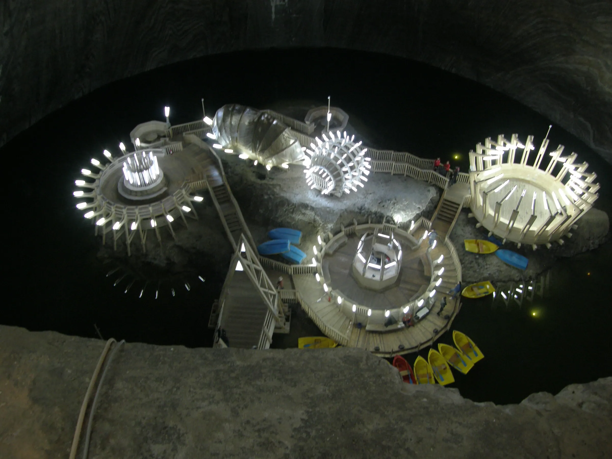 The lit underground park and lake inside Salina Turda