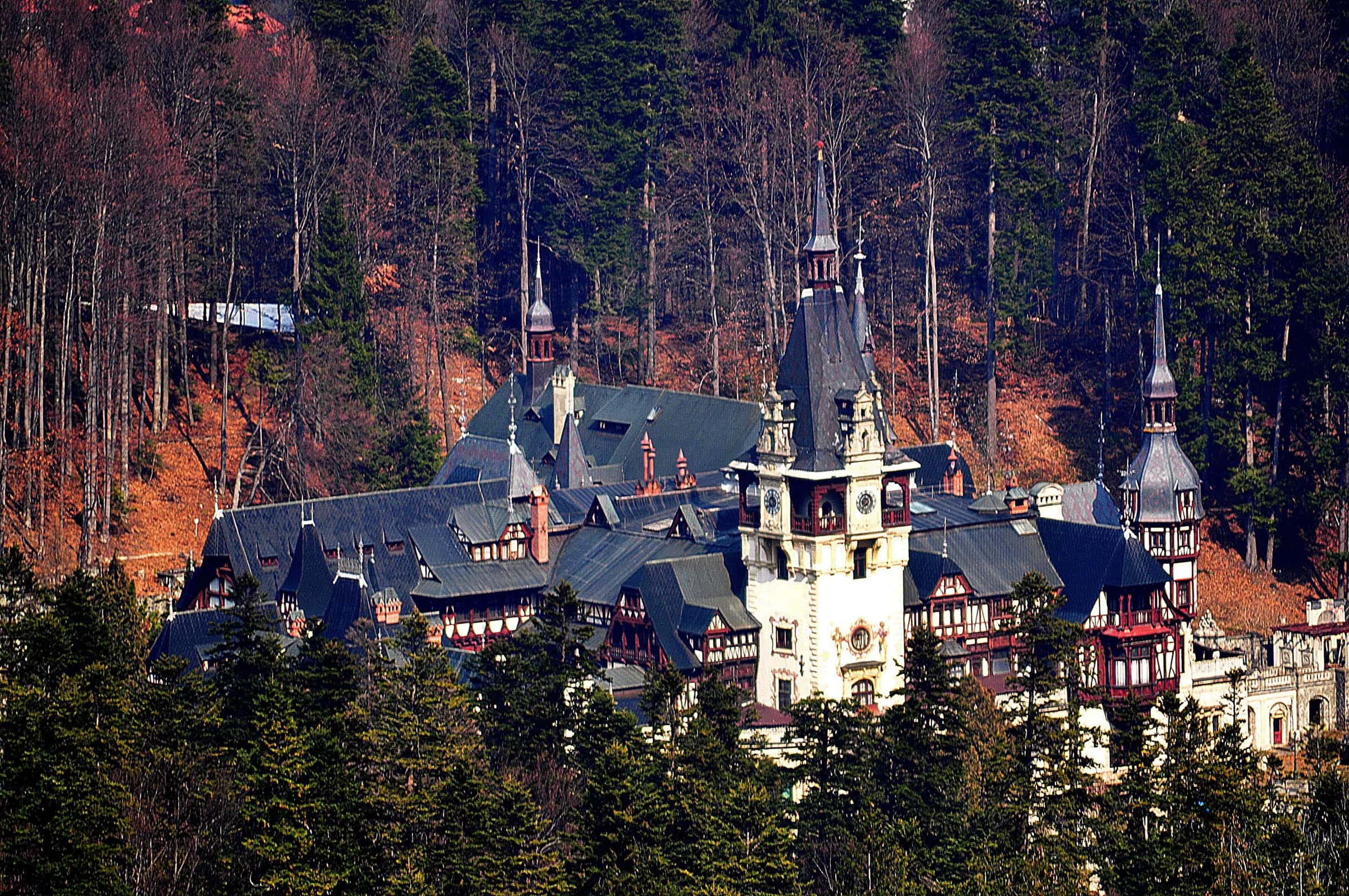 Peleș Castle among autumn forest in Sinaia