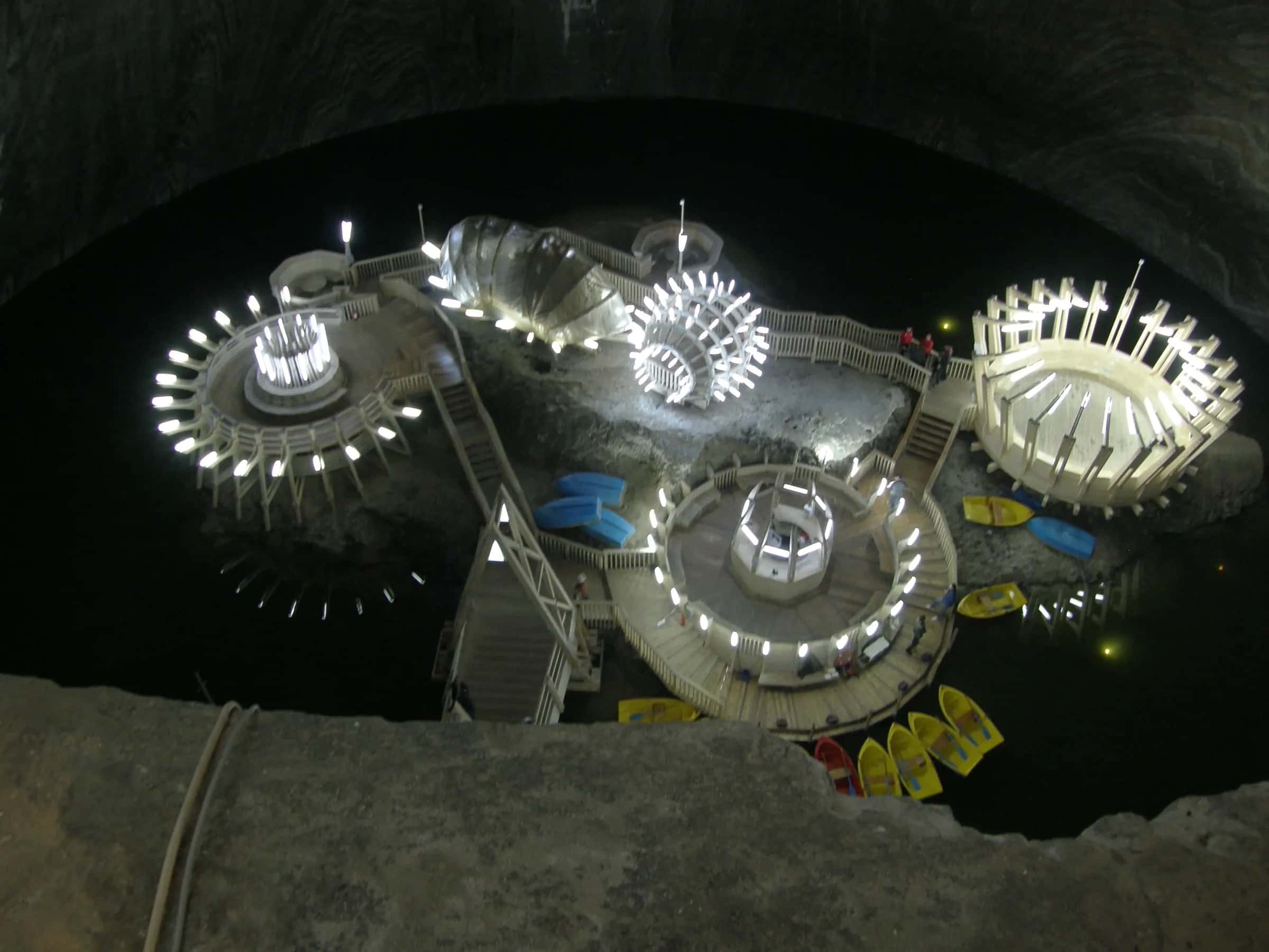 The lit underground park and lake inside Salina Turda